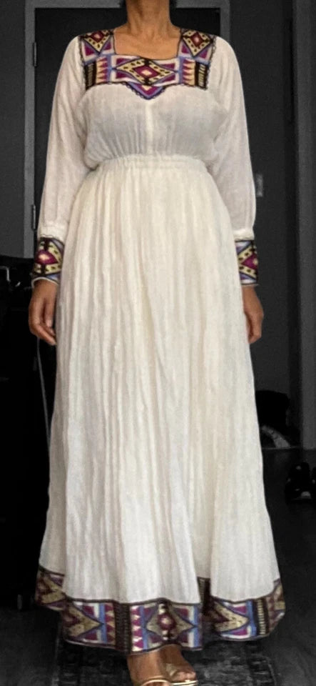 Elegant White Habesha Kemis with Colorful Hem Embroidery