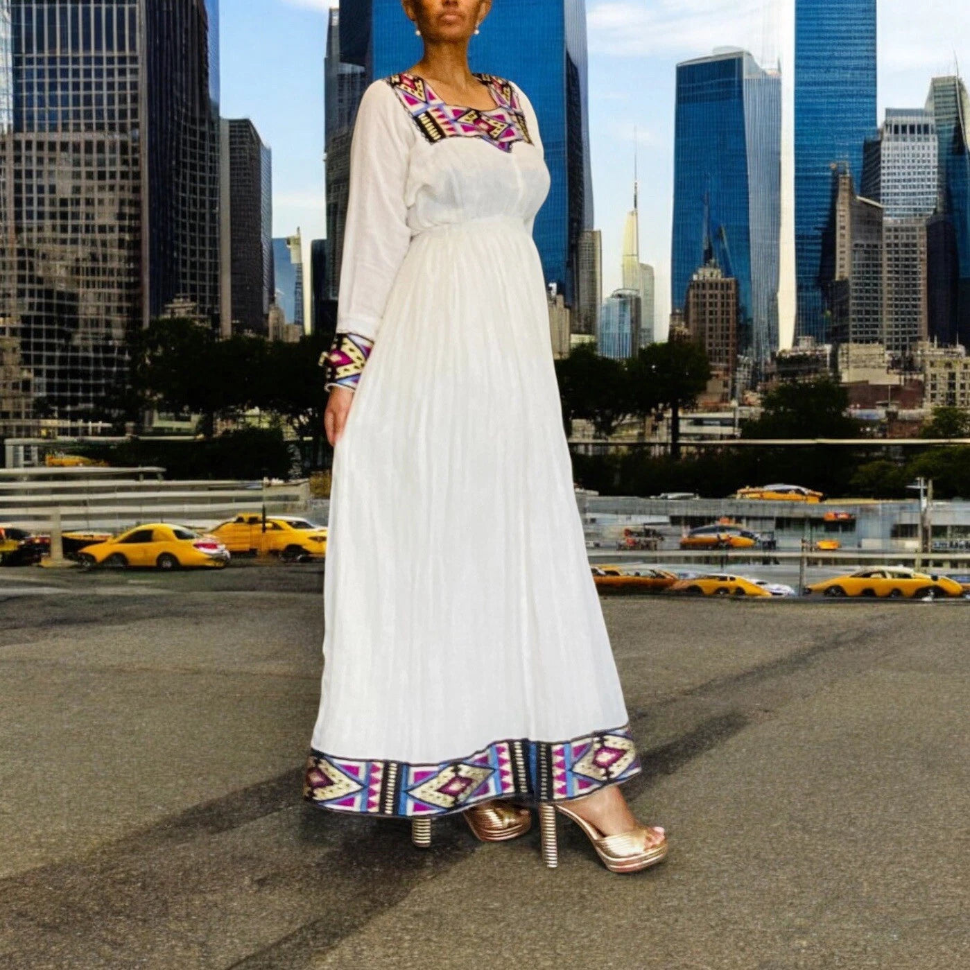 Elegant White Habesha Kemis with Colorful Hem Embroidery