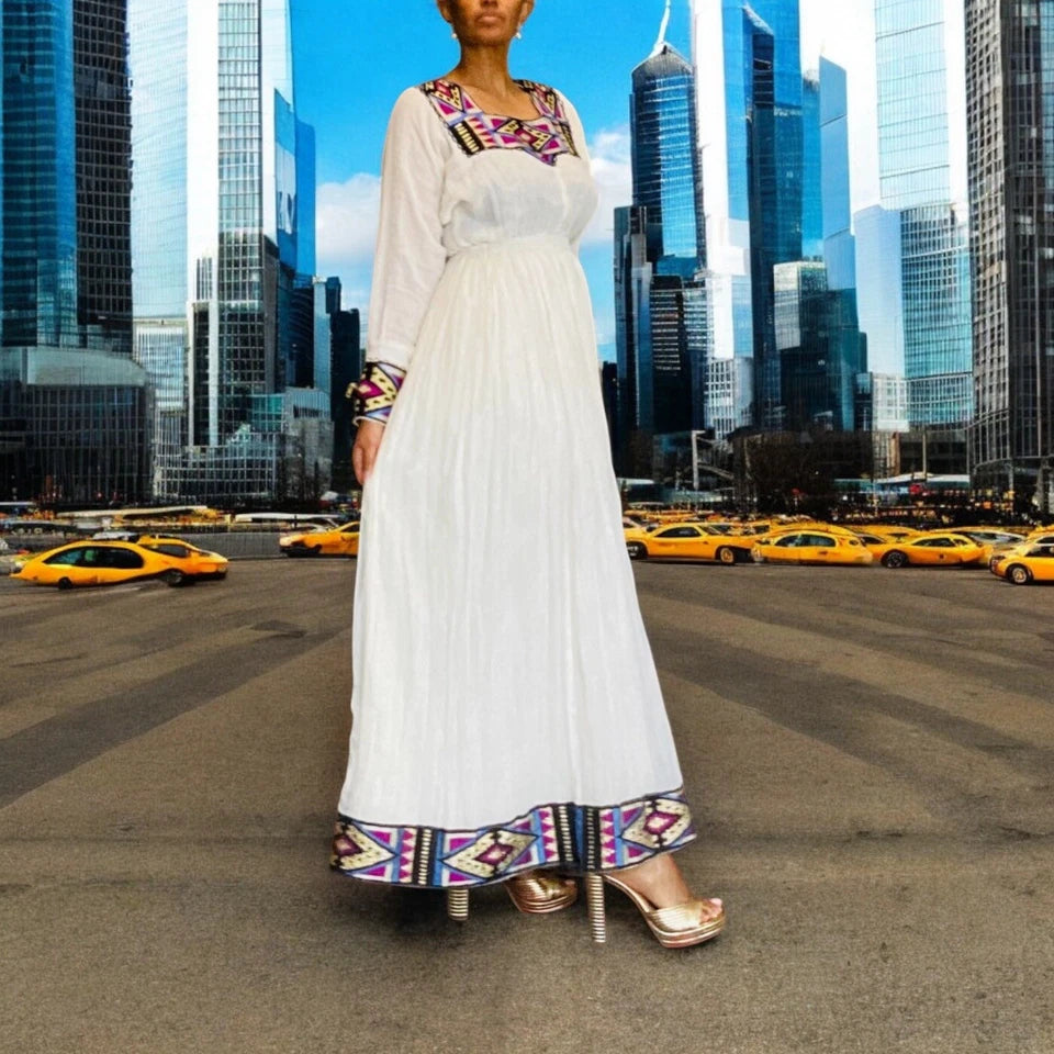 Elegant White Habesha Kemis with Colorful Hem Embroidery