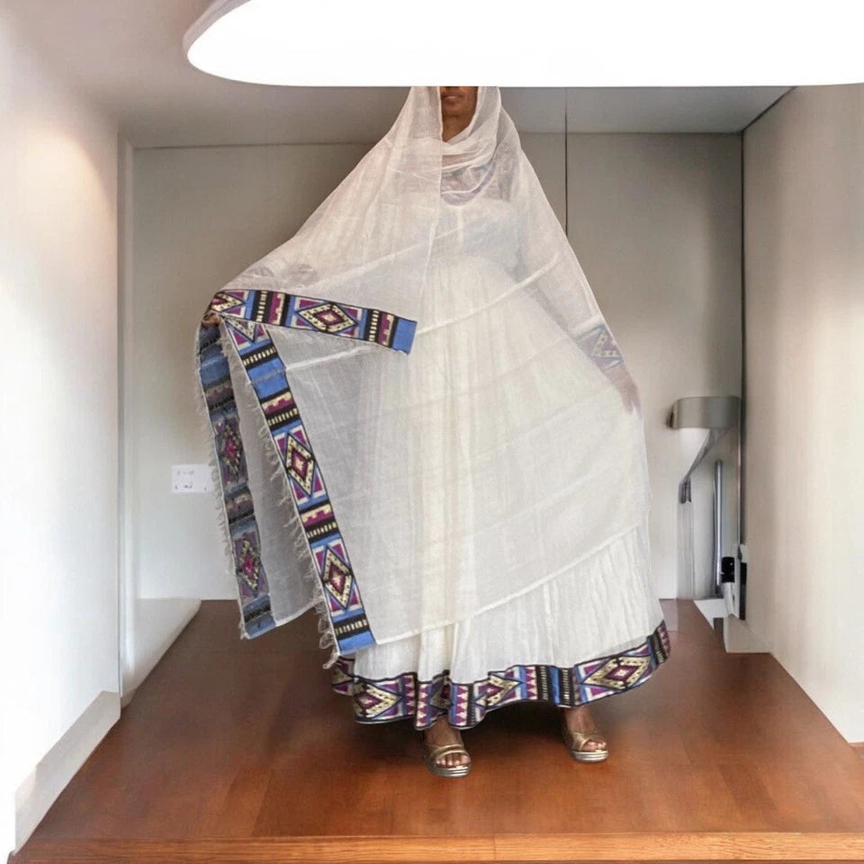 Elegant White Habesha Kemis with Colorful Hem Embroidery