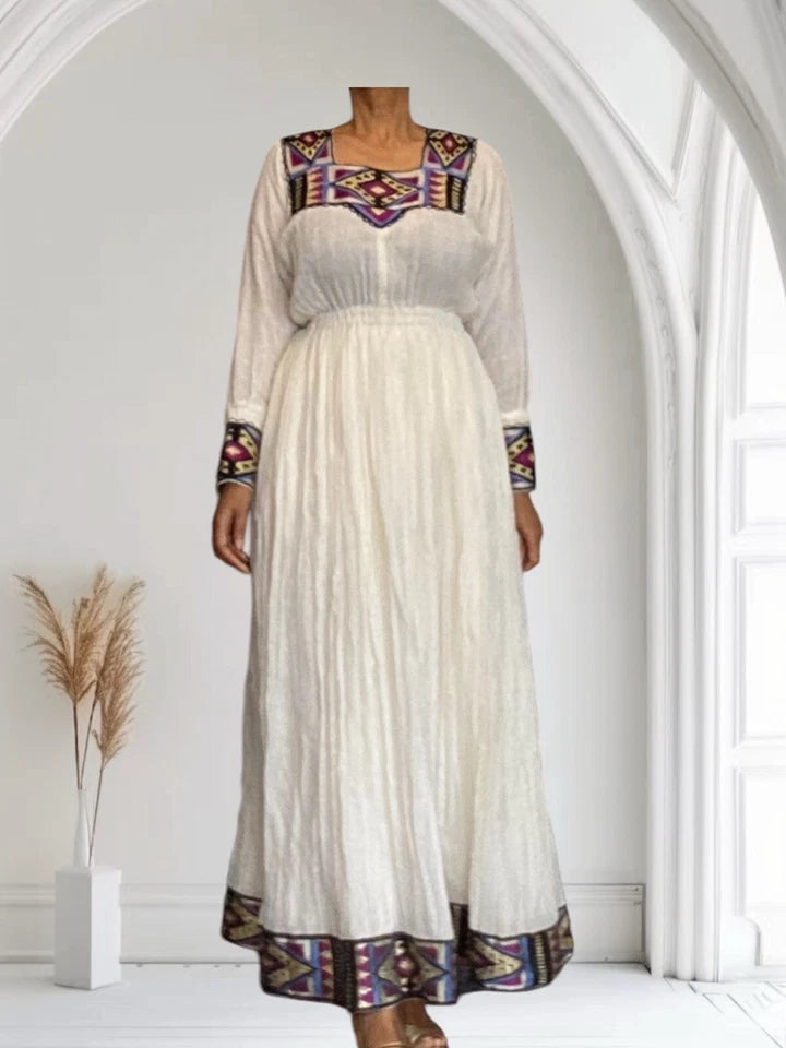 Elegant White Habesha Kemis with Colorful Hem Embroidery